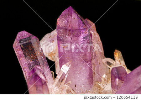 Macro of amethyst mineral stone on black background 120654119