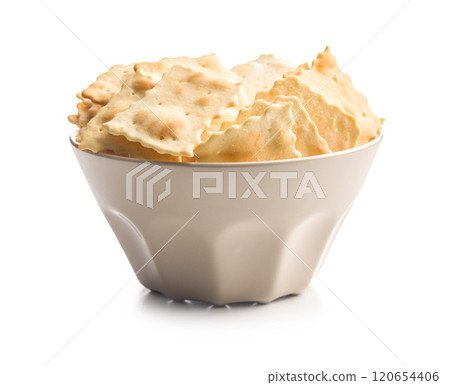 A crispy salted crackers in bowl isolated on white background. 120654406