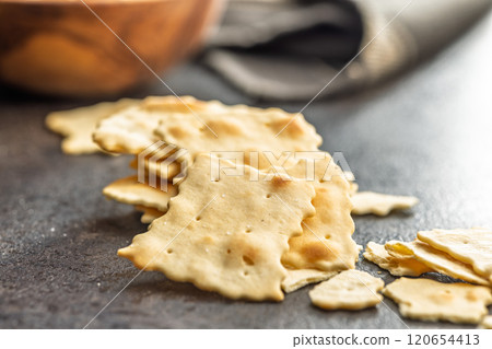 A crispy salted crackers on black table. A crispy salted crackers on black table. 120654413