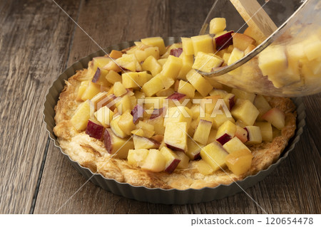 Sweet potato and apple quiche, tart, pie. Sweet potatoes and apples fried in butter are put into the pie crust. 120654478