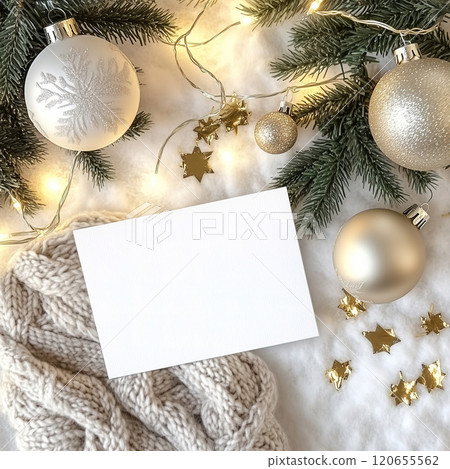 A white card surrounded by Christmas decorations and a scarf. Blank white Christmas holiday postcard mockup 120655562