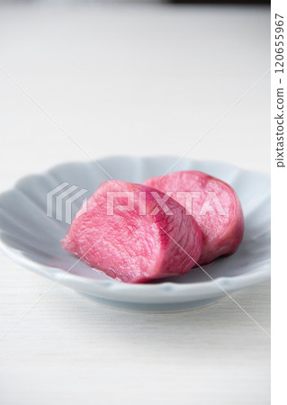Pickled Atsumi turnips served on a small plate 120655967