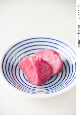 Pickled Atsumi turnips served on a small plate 120655969