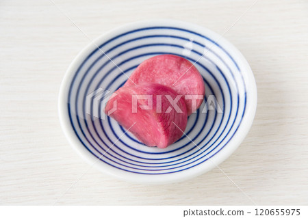 Pickled Atsumi turnips served on a small plate 120655975