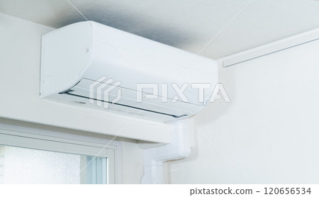 Air conditioner installed on the ceiling of the room 120656534