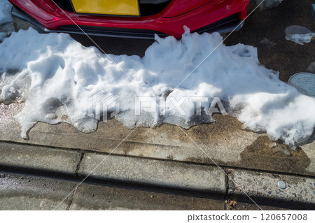 I'm bothered by snow piled up in front of my garage. 120657008