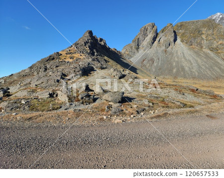 Stokksnes beach features massive rocky Vestrahorn mountains in breathtaking freezing cold icelandic setting. Scenery of beautiful coastline with steep slopes and nordic waterfront. Stokksnes beach features massive rocky Vestrahorn mountains in breathtaking freezing cold icelandic setting. Scenery of beautiful coastline with steep slopes and nordic waterfront. 120657533