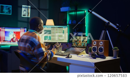 African american man talking on video call using personal computer, discussing about accounting infographics. Young adult communicating online and examining monthly revenue balance. Camera B. African american man talking on video call using personal computer, discussing about accounting infographics. Young adult communicating online and examining monthly revenue balance. Camera B. 120657583