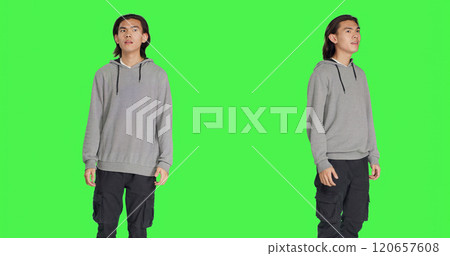 Person having surprised reaction after seeing something, saying wow and being amazed by it. Asian man in shock admiring beautiful thing, feeling pleased and optimistic, greenscreen. 120657608