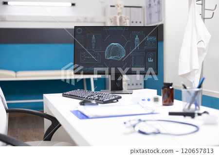 Modern desk in medical office holds a computer showing hud imaging of body and brain, emphasizing cutting-edge diagnostic technology. Nobody in clinic room, allowing focus on equipment and analysis. Modern desk in medical office holds a computer showing hud imaging of body and brain, emphasizing cutting-edge diagnostic technology. Nobody in clinic room, allowing focus on equipment and analysis. 120657813