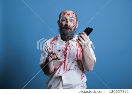 Portrait of mindless businessman worked to death taking telephone calls. Man working like zombie, using mobile phone, capitalism slave metaphor, isolated over studio background 120657821
