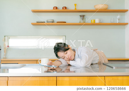 Depressed woman in the kitchen Depressed woman in the kitchen 120658666