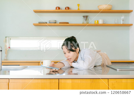 Depressed woman in the kitchen Depressed woman in the kitchen 120658667