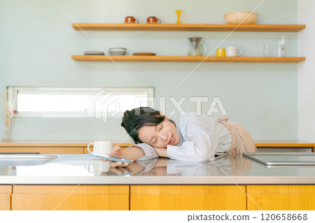Depressed woman in the kitchen 120658668