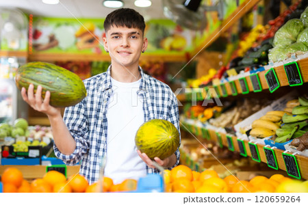 Confident guy customer chooses melons Confident guy customer chooses melons 120659264