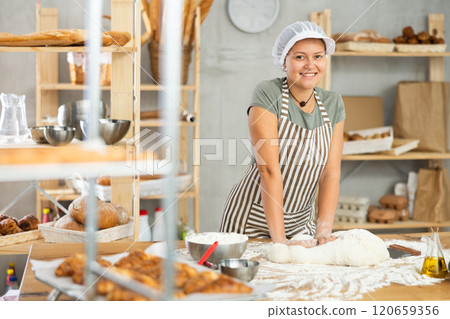 Woman works in bakery as baker, kneads dough, works with flour. Woman works in bakery as baker, kneads dough, works with flour. 120659356