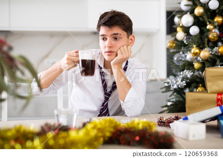 man suffering while hungover after new year party 120659368