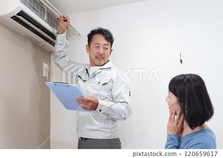 Air conditioner installer and customer Air conditioner installer and customer 120659617