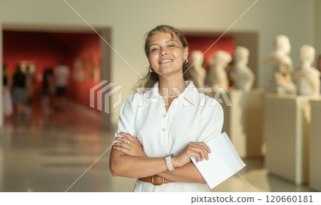 Woman with sheet piece of paper in hands view sculpture in museum hall Woman with sheet piece of paper in hands view sculpture in museum hall 120660181