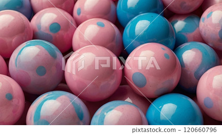 A multitude of pink and blue marbles are closely packed, showcasing their glossy surfaces and playful colors that create a cheerful visual effect. 120660796