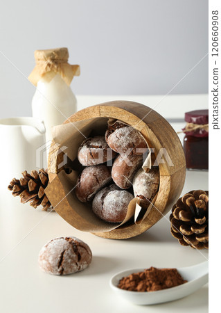 Delicious crinkle cookies in a plate, on a light background. 120660908