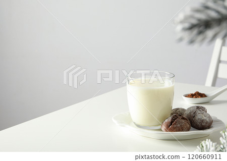 Delicious Grinkle cookies in a plate, with milk, on a light background. 120660911