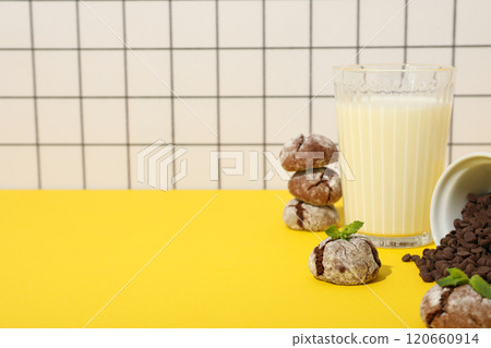 Appetizing Grinkle cookies with milk, on a yellow background. 120660914