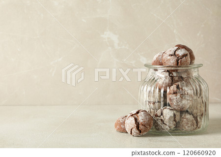 Delicious Grinkle cookies in a glass jar, on a light background. 120660920