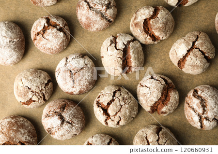 Appetizing crinkle cookies, on parchment, on a dark background. Appetizing crinkle cookies, on parchment, on a dark background. 120660931