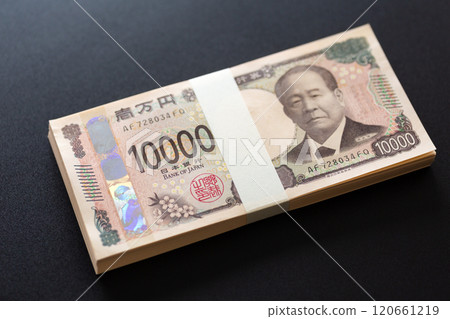 A stack of new 10,000 yen bills placed on a black background A stack of new 10,000 yen bills placed on a black background 120661219