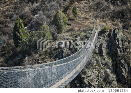 Sky Bridge in Chunkurchak Gorge, Kyrgyzstan. Suspension excursion bridge Sky Bridge in Chunkurchak Gorge, Kyrgyzstan. Suspension excursion bridge 120661284