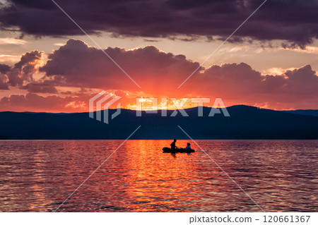 Romantic boat rides on the lake against the backdrop of the evening dawn 120661367