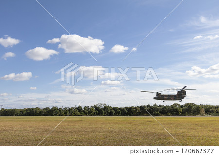 A helicopter taking off under a blue sky 120662377