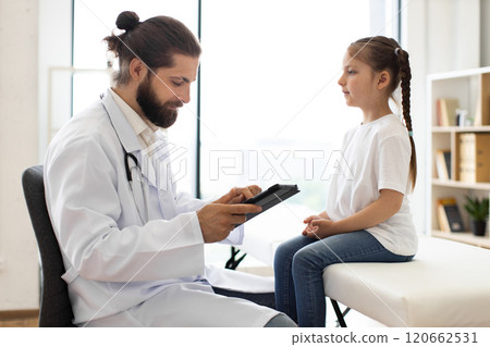 Doctor conducting health examination of young girl in medical office 120662531