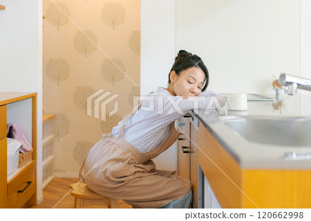 Depressed woman in the kitchen 120662998