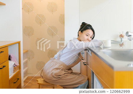 Depressed woman in the kitchen 120662999