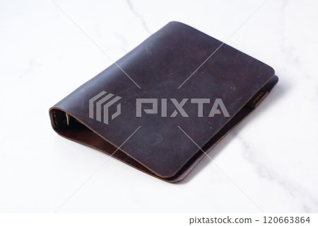 Image of doing desk work with a brown leather notebook Image of doing desk work with a brown leather notebook 120663864