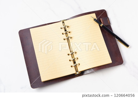 Image of a ring-type system organizer open while doing desk work Image of a ring-type system organizer open while doing desk work 120664056