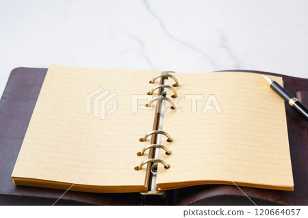 Image of a ring-type system organizer open while doing desk work Image of a ring-type system organizer open while doing desk work 120664057