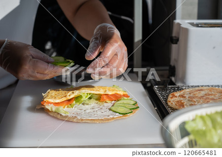 Chef prepares flatbread with salmon. Quesadilla.  120665481