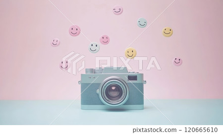 Vintage camera sits on a two toned pastel background, capturing the essence of happy moments as colorful emojis float above, symbolizing positive feedback and engagement on social media platforms 120665610