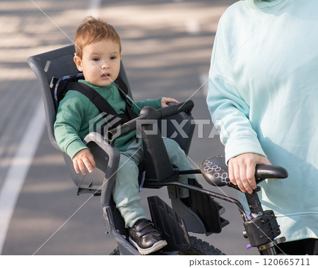 Portrait of Caucasian little boy on bicycle chair.  120665711