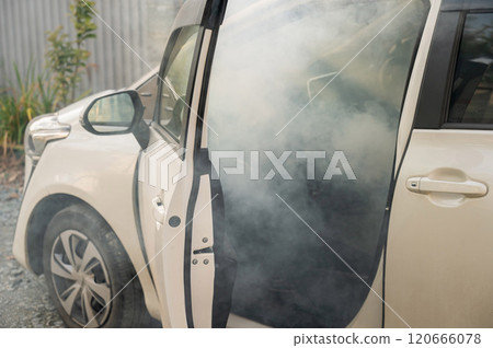 Smoke is coming from inside the car. Smoke is coming from inside the car. 120666078