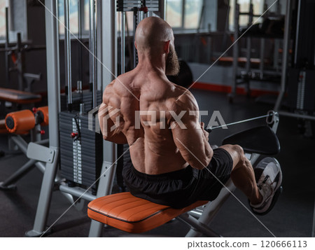 Caucasian man doing rowing exercises on a rowing machine. Caucasian man doing rowing exercises on a rowing machine. 120666113