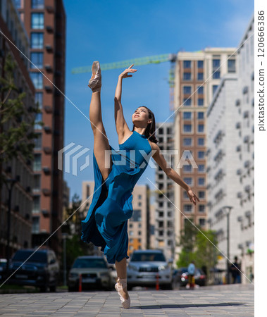 Beautiful Asian ballerina dancing outdoors. Urban landscape. 120666386