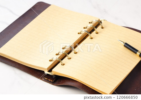 Image of a ring-type system organizer open while doing desk work Image of a ring-type system organizer open while doing desk work 120666850