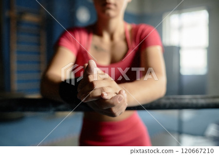 Close up on hands of sportswoman clapping hands dusted with chalk while particles of powder floating in air, gymnast preparation scene, copy space Close up on hands of sportswoman clapping hands dusted with chalk while particles of powder floating in air, gymnast preparation scene, copy space 120667210