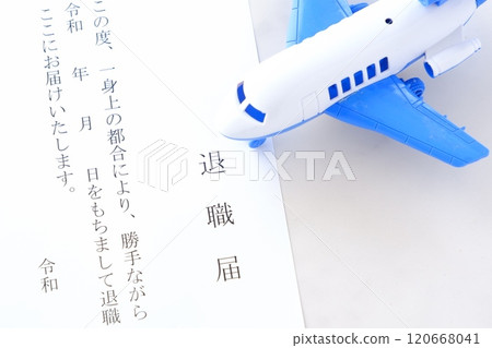 A resignation letter and an airplane placed on an office desk, representing the image of leaving the company and taking flight to freedom 120668041