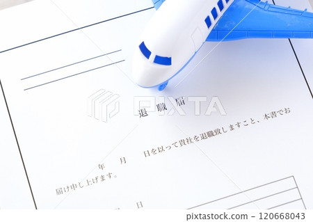A resignation letter and an airplane placed on an office desk, representing the image of leaving the company and taking flight to freedom A resignation letter and an airplane placed on an office desk, representing the image of leaving the company and taking flight to freedom 120668043