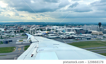 Descending airplane wing over toulouse blagnac airport and aeroconstellation museum against a cloudy sky 120668178
